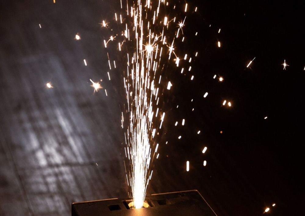 Close-up of a cold spark fountain machine firing bright indoor wedding fireworks