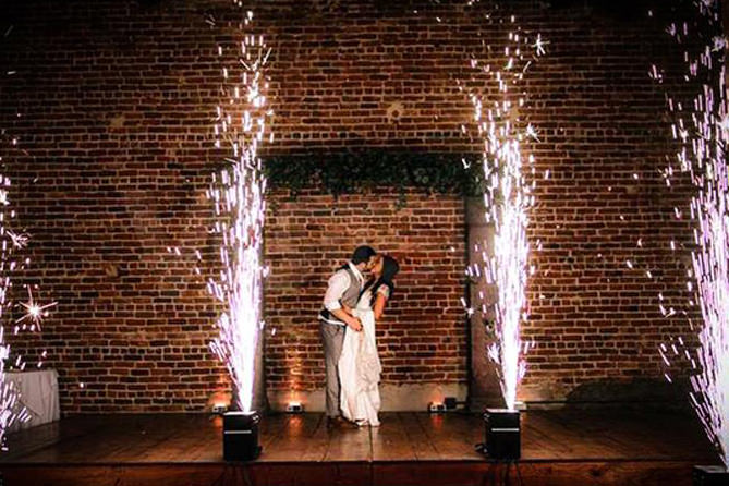 Bride and groom kissing during their first dance framed by cold spark machine fountains — indoor sparkler hire for weddings in Worcestershire by Blue Diamond Entertainment