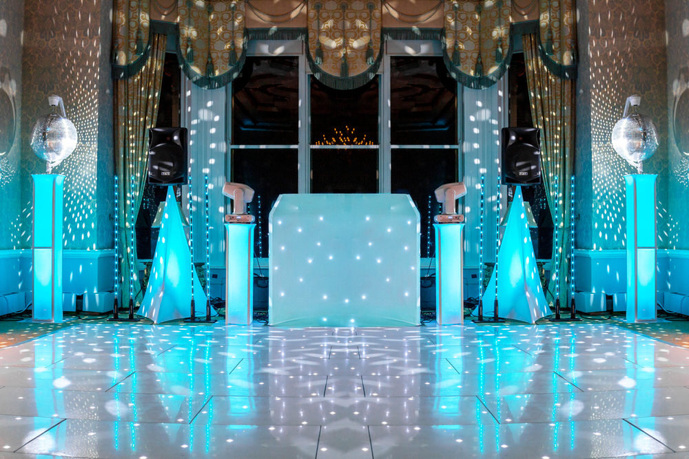 Blue Diamond Entertainment professional wedding DJ setup with white LED dance floor and teal uplighting at a Cotswolds wedding venue