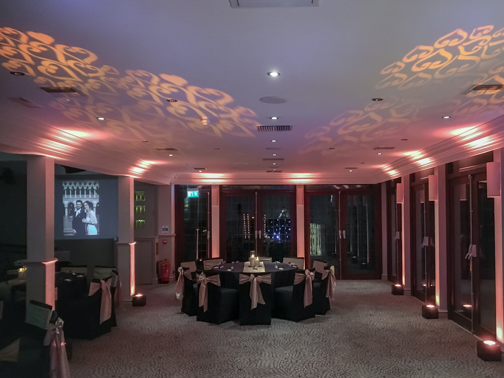 Pink uplighting and ornate damask gobo ceiling projections filling the Garden Room at Hogarths Stone Manor, Kidderminster, Worcestershire, wedding uplighting and gobo projection hire by Blue Diamond Entertainment